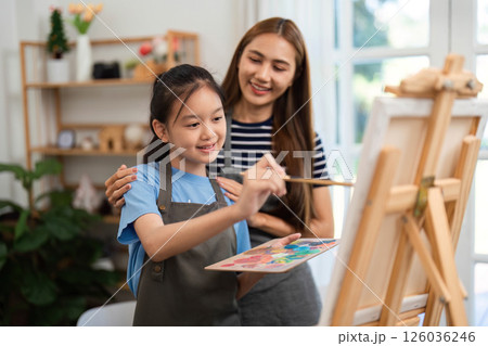 Family time enjoying painting together with smiles and creativity Family time enjoying painting together with smiles and creativity 126036246