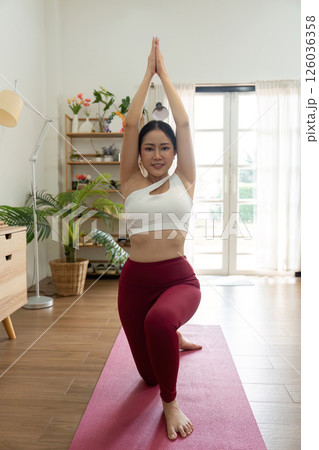 Yoga and Exercise. A woman reaching upward in a yoga pose, embracing balance and tranquility. 126036358