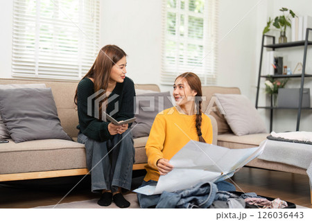 Friendship and bonding over packing clothes for a trip Friendship and bonding over packing clothes for a trip 126036443