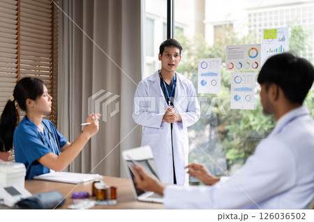 Medical presentation: Doctor sharing insights with team during discussion Medical presentation: Doctor sharing insights with team during discussion 126036502