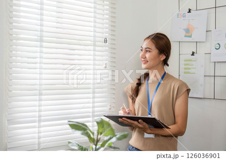 Sustainability and growth: woman smiling while exploring ESG solutions Sustainability and growth: woman smiling while exploring ESG solutions 126036901