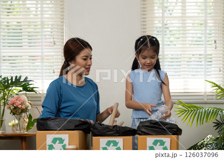 Waste Management and Family Bonding. A child and an adult organizing recyclables in a home setting. Waste Management and Family Bonding. A child and an adult organizing recyclables in a home setting. 126037096