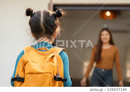 Love and Support for School Adventures. A girl turns to her mother as they prepare for a new day together. Love and Support for School Adventures. A girl turns to her mother as they prepare for a new day together. 126037194