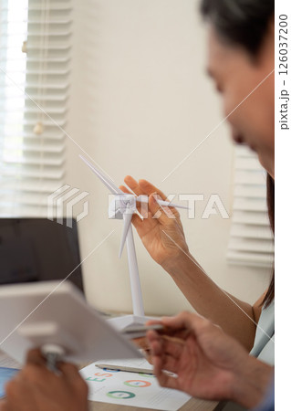 Sustainability ESG discussion with professionals around wind turbines 126037200