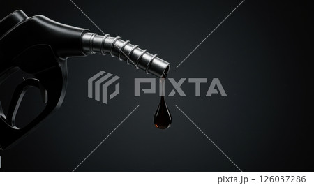 Fuel nozzle with a single drop of viscous dark liquid. Heavy duty black dispenser with a thick droplet. Automotive and industrial concept. 126037286