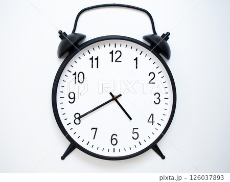 Black Retro Alarm Clock Showing 04:40 or 16:40. Classic Bell Style on White Wood Background. Black Retro Alarm Clock Showing 04:40 or 16:40. Classic Bell Style on White Wood Background. 126037893