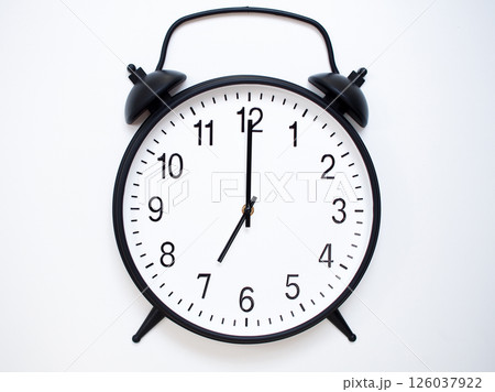 Black Retro Alarm Clock Showing 07:00 or 19:00. Classic Bell Style on White Wood Background. 126037922