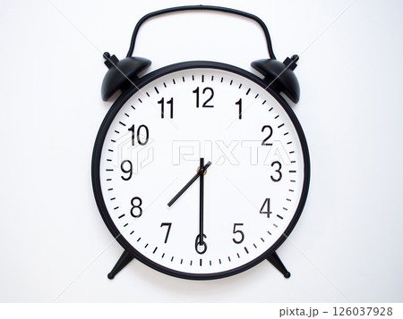 Black Retro Alarm Clock Showing 07:30 or 19:30. Classic Bell Style on White Wood Background. Black Retro Alarm Clock Showing 07:30 or 19:30. Classic Bell Style on White Wood Background. 126037928