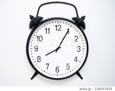 Black Retro Alarm Clock Showing 08:05 or 20:05. Classic Bell Style on White Wood Background. Black Retro Alarm Clock Showing 08:05 or 20:05. Classic Bell Style on White Wood Background. 126037938