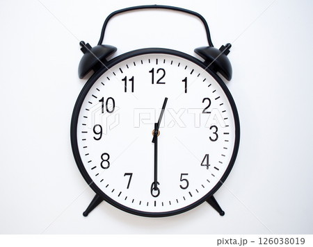 Black Retro Alarm Clock Showing 00:30 or 12:30. Classic Bell Style on White Wood Background. 126038019