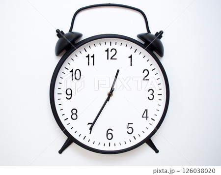 Black Retro Alarm Clock Showing 00:35 or 12:35. Classic Bell Style on White Wood Background. 126038020