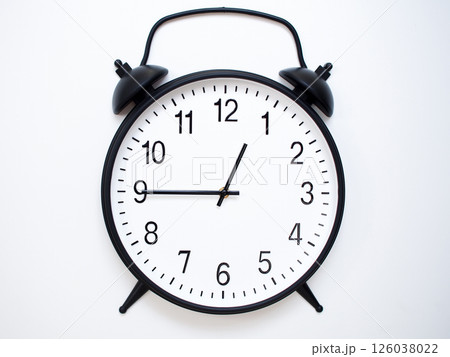 Black Retro Alarm Clock Showing 00:45 or 12:45. Classic Bell Style on White Wood Background. 126038022