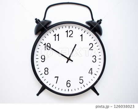 Black Retro Alarm Clock Showing 00:50 or 12:50. Classic Bell Style on White Wood Background. 126038023