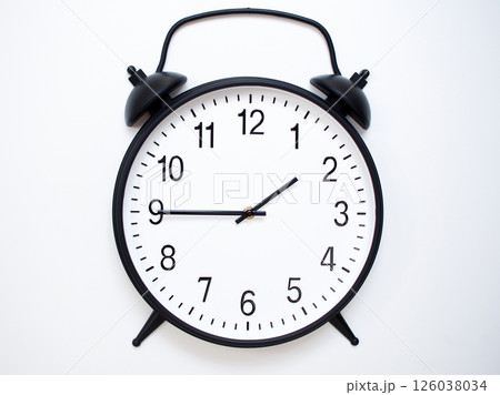 Black Retro Alarm Clock Showing 01:45 or 13:45. Classic Bell Style on White Wood Background. 126038034