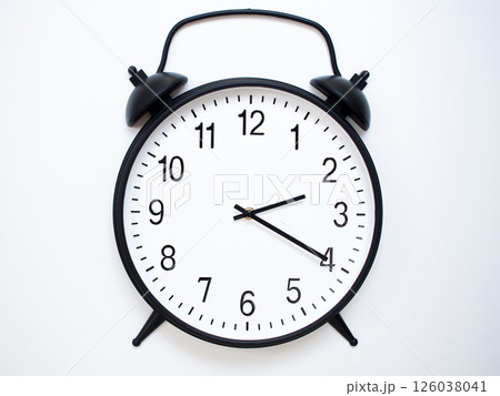 Black Retro Alarm Clock Showing 02:20 or 14:20. Classic Bell Style on White Wood Background. Black Retro Alarm Clock Showing 02:20 or 14:20. Classic Bell Style on White Wood Background. 126038041