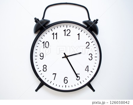 Black Retro Alarm Clock Showing 02:25 or 14:25. Classic Bell Style on White Wood Background. Black Retro Alarm Clock Showing 02:25 or 14:25. Classic Bell Style on White Wood Background. 126038042