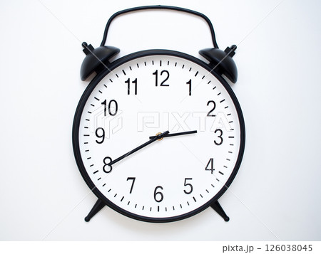 Black Retro Alarm Clock Showing 02:40 or 14:40. Classic Bell Style on White Wood Background. Black Retro Alarm Clock Showing 02:40 or 14:40. Classic Bell Style on White Wood Background. 126038045