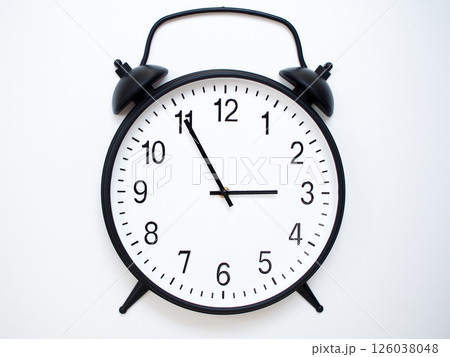 Black Retro Alarm Clock Showing 02:55 or 14:55. Classic Bell Style on White Wood Background. 126038048