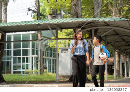 Back to School and Soccer Fun. A laughter-filled moment as a boy and his mentor walk hand in hand after school. Back to School and Soccer Fun. A laughter-filled moment as a boy and his mentor walk hand in hand after school. 126038257