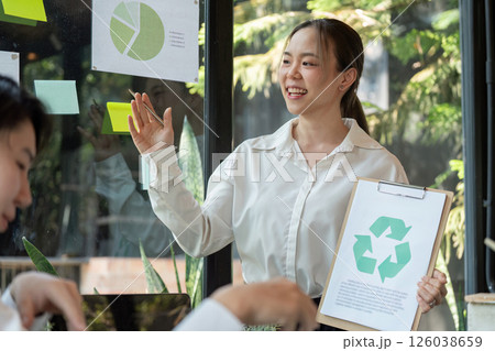 Eco-friendly Initiatives and Engagement. A presenter discussing recycling and sustainability goals in a professional setting. Eco-friendly Initiatives and Engagement. A presenter discussing recycling and sustainability goals in a professional setting. 126038659
