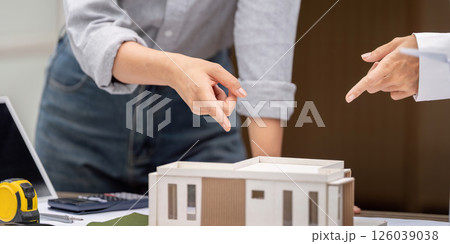 Sustainability and Architectural Design. Professionals discussing a sustainable building model. Sustainability and Architectural Design. Professionals discussing a sustainable building model. 126039038