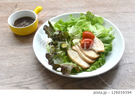 grilled  slice chicken breast with vegetable salad on plate dressing Japanese sesame oil soy sauce 126039394