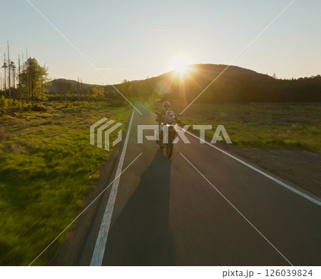 Motorcycle Rider in a Beautiful Sunset Rural Landscape. Action Sports Shot of Touring Motorbike. 126039824