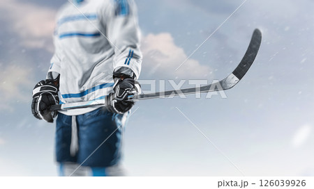 Focused on the hockey stick. Sports emotions. Professional hockey player. Professional ice hockey player in the mountains 126039926