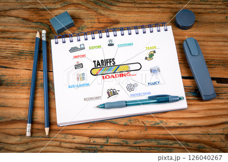 Tariffs Loading Concept. Notepad on a wooden texture background Tariffs Loading Concept. Notepad on a wooden texture background 126040267