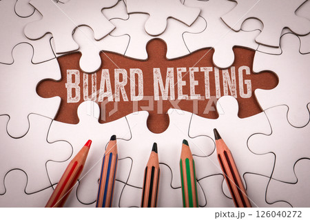 Board Meeting. White puzzle pieces and colored pencils 126040272