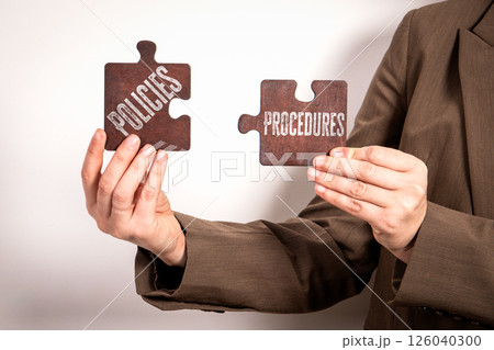 Policies and Procedures Concept with Puzzle Pieces in Hands Policies and Procedures Concept with Puzzle Pieces in Hands 126040300