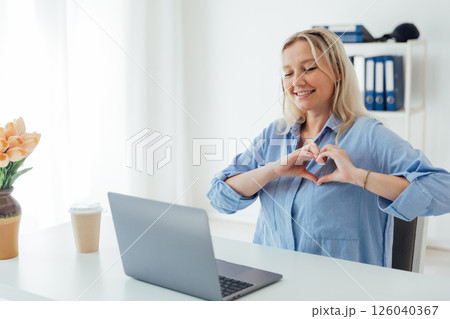 Business blonde woman showing her hands heart with laptop Business blonde woman showing her hands heart with laptop 126040367
