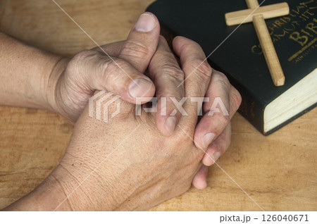 Two hands joined in reverent prayer reflect surrender, connection, and sacred communion with our heavenly Father above. Two hands joined in reverent prayer reflect surrender, connection, and sacred communion with our heavenly Father above. 126040671