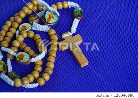 Holy Rosary on purple cloth reminds us of Christ royalty and divine passion. 126040690