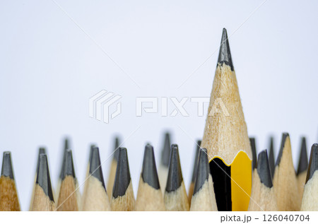 A pencil standing out from the rest representing Courage or Leadership with customizable space for text A pencil standing out from the rest representing Courage or Leadership with customizable space for text 126040704