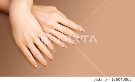 Beautiful Female Hands with bright orange Manicure like Candy Corn. Manicured Nails with Yellow Gel Polish. Halloween Style Beautiful Female Hands with bright orange Manicure like Candy Corn. Manicured Nails with Yellow Gel Polish. Halloween Style 126040865