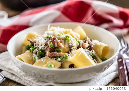 Typical Italian pasta Calamarata with bacon, fresh peas and parmesan cheese Typical Italian pasta Calamarata with bacon, fresh peas and parmesan cheese 126040968