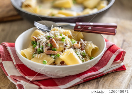 Typical Italian pasta Calamarata with bacon, fresh peas and parmesan cheese 126040971