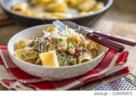 Typical Italian pasta Calamarata with bacon, fresh peas and parmesan cheese 126040972