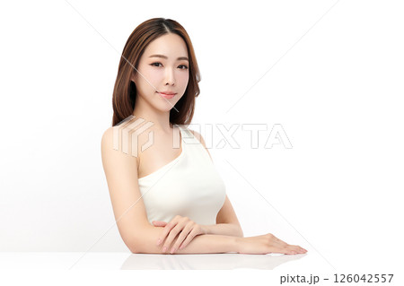 A beautiful young Asian woman with clean, fresh skin against a white background. Skincare, facial treatment, cosmetology, beauty, and spa. An elegant portrait of an Asian woman. 126042557