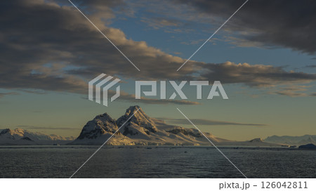 Awe inspiring polar landscape with calm waters, glaciers, mountains and sunrise, Antarctica 126042811