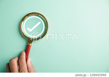 Magnifying glass and check mark icon symbolize the concept of verifying document authenticity. Emphasizing the significance of following rules, conduct, company regulations for success and compliance. Magnifying glass and check mark icon symbolize the concept of verifying document authenticity. Emphasizing the significance of following rules, conduct, company regulations for success and compliance. 126042940