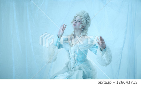 Dreamy woman as medieval duchess trapped behind sheer veil, styled in rococo gown, portraying fragile elegance and surreal nobility Dreamy woman as medieval duchess trapped behind sheer veil, styled in rococo gown, portraying fragile elegance and surreal nobility 126043715