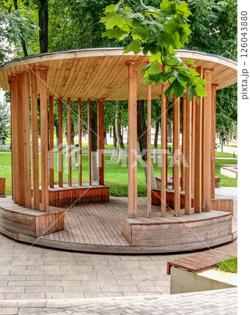 Beautiful modern wooden round wooden gazebo in the park Beautiful modern wooden round wooden gazebo in the park 126043880