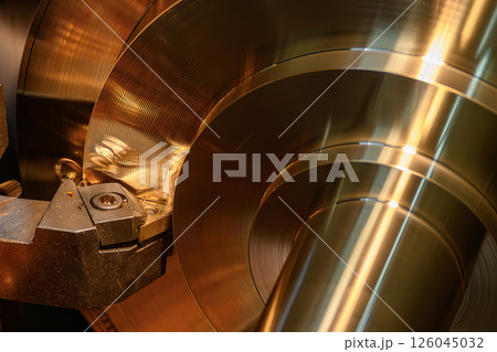 Close up scene the lathe machine finish cut the brass material parts by chip insert tool. Close up scene the lathe machine finish cut the brass material parts by chip insert tool. 126045032
