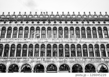 The grandeur of the Old Procuracies showcases intricate arches and windows at Saint Marc Square, Venice, highlighting exquisite Venetian Gothic architecture and historic charm. The grandeur of the Old Procuracies showcases intricate arches and windows at Saint Marc Square, Venice, highlighting exquisite Venetian Gothic architecture and historic charm. 126045220