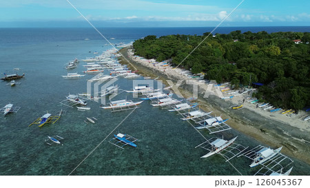 Tropical island and traditional boats on turquoise waters 126045367