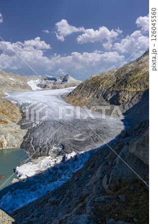 High mountain glacier Rhonegletscher and glacial lake on Furkapass in summer Switzerland High mountain glacier Rhonegletscher and glacial lake on Furkapass in summer Switzerland 126045560
