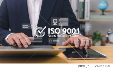 ISO 9001 Standard certification standardisation quality control concept, Certified and quality, Businessman use computer and tablet with text ISO 9001 for quality management of organizations. 126045796