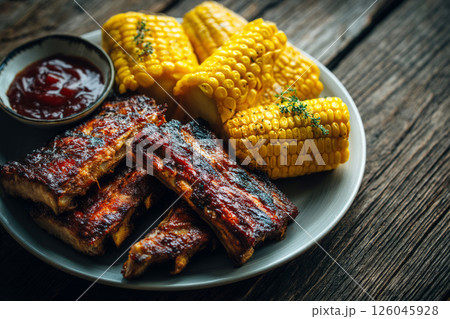 Grilled pork ribs with barbecue sauce and corn 126045928